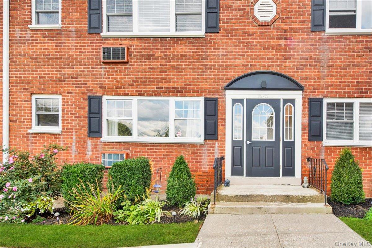 a front view of a house with garden