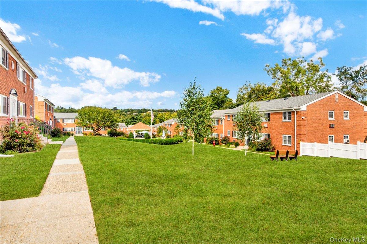 1879 Crompond Road, Unit G10 Peekskill, NY 10566 - Photo 14 of 18 a view of a backyard with plants and a garden