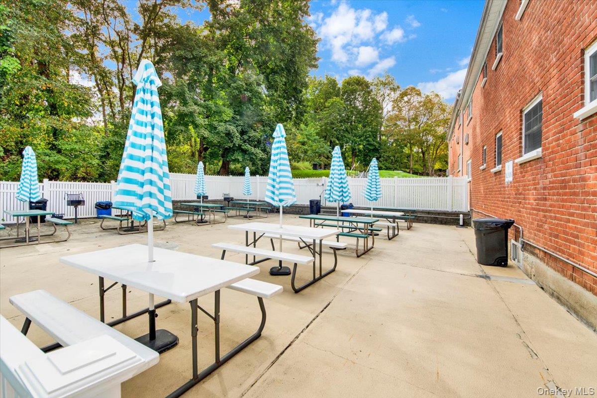 1879 Crompond Road, Unit G10 Peekskill, NY 10566 - Photo 15 of 18 a view of a patio with chairs and tables