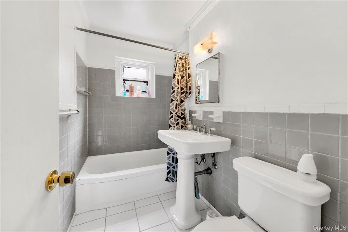 1879 Crompond Road, Unit G10 Peekskill, NY 10566 - Photo 2 of 18 a bathroom with a sink a toilet a mirror and bathtub