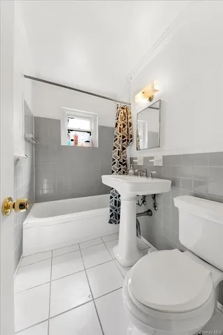 a bathroom with a sink a toilet and bathtub