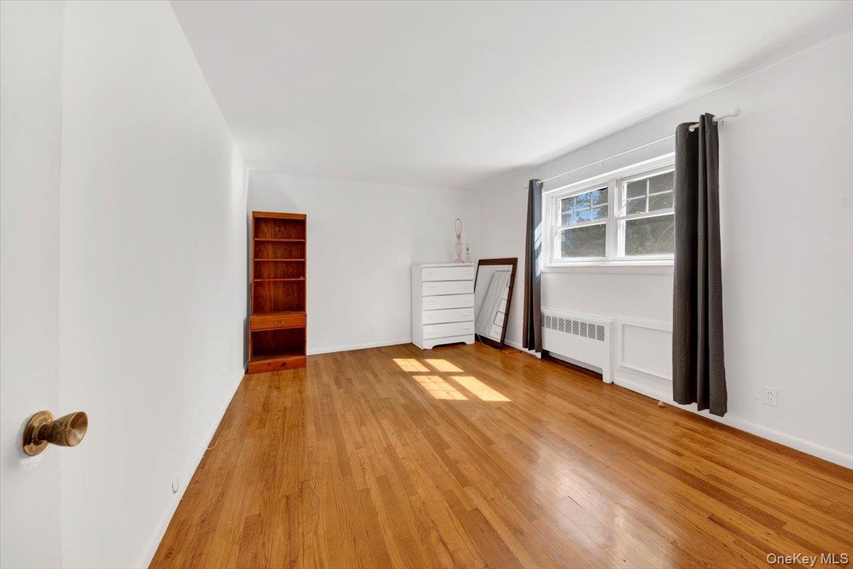 1879 Crompond Road, Unit G10 Peekskill, NY 10566 - Photo 4 of 18 a view of empty room with wooden floor and cabinet