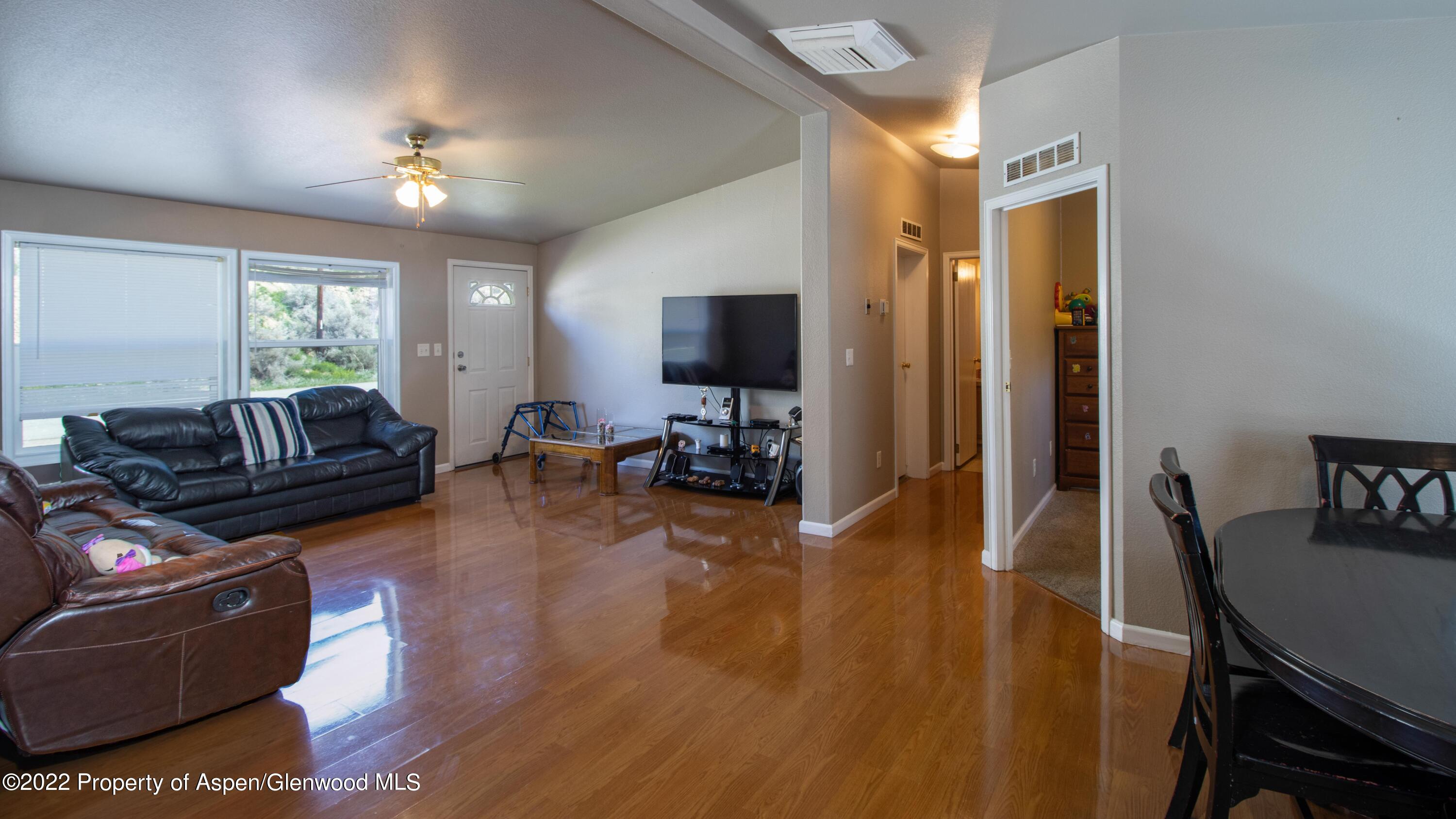 148 Ray Avenue Rifle, CO 81650 - Photo 7 of 13 a living room with furniture and a flat screen tv