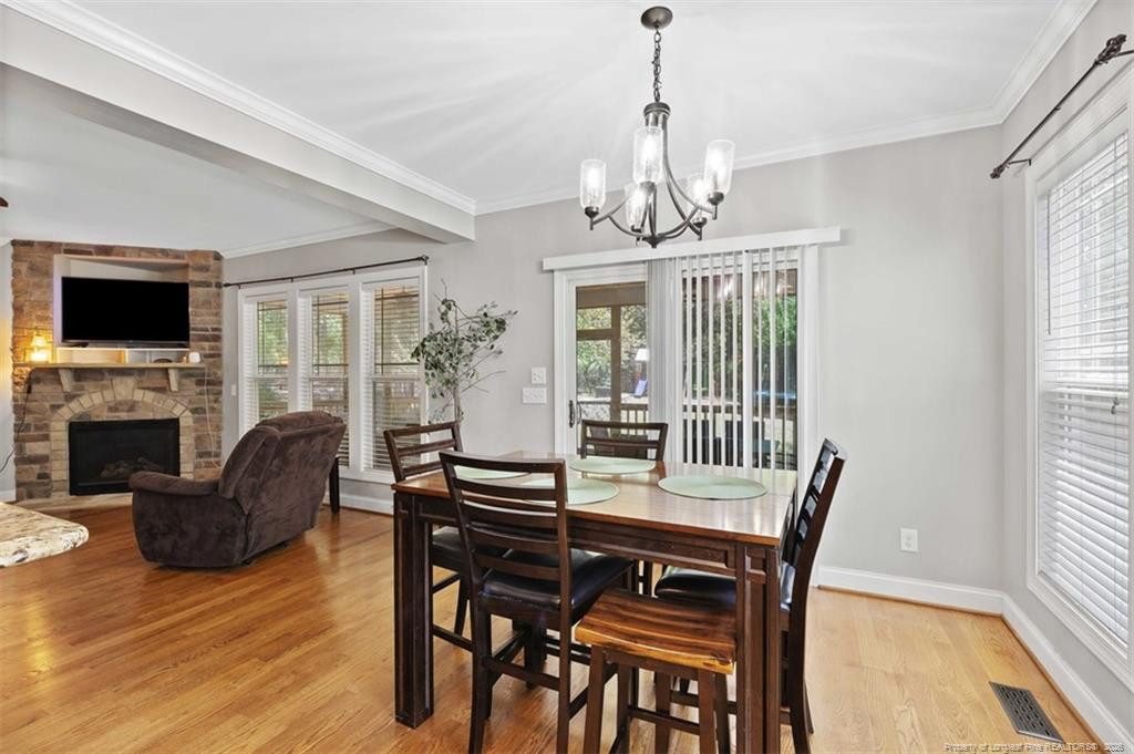 704 Micahs Way North Spring Lake, NC 28390 - Photo 15 of 43 a view of a dining room with furniture window and wooden floor