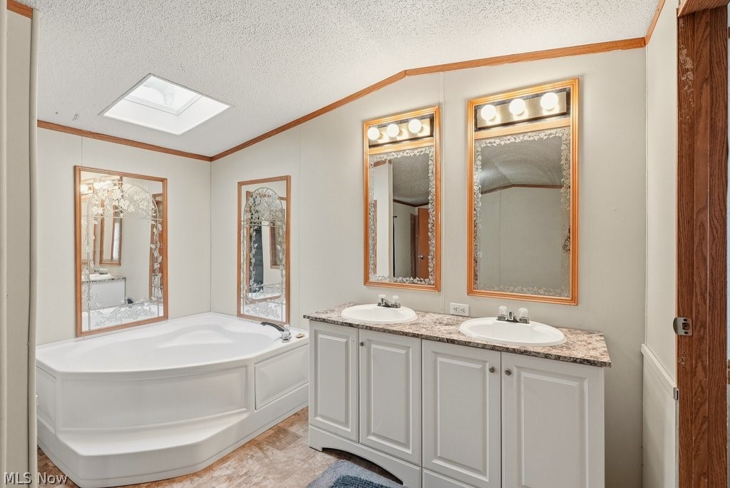 6507 Robby Lane Ravenna, OH 44266 - Photo 16 of 25 Unfurnished bedroom with double vanity, light colored carpet, ornamental molding, and a bath