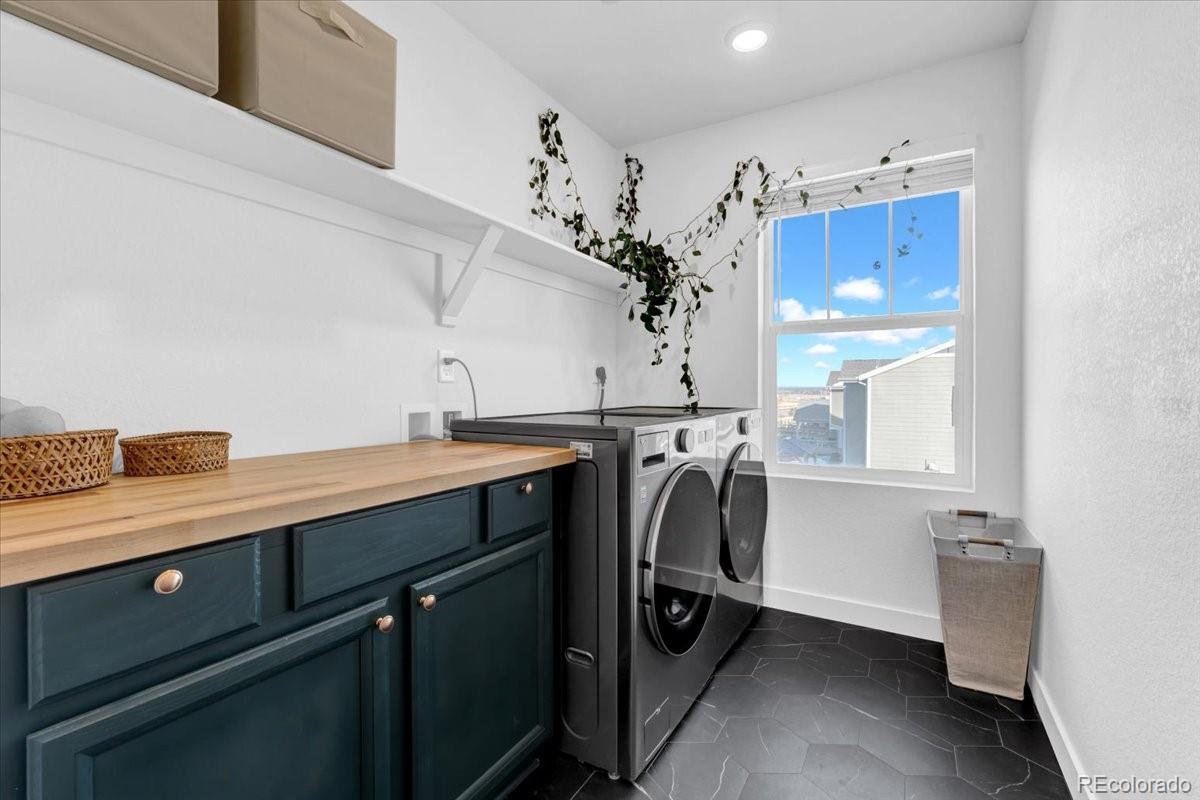 5453 Inland Avenue Firestone, CO 80504 - Photo 21 of 49 a utility room with cabinets and washer