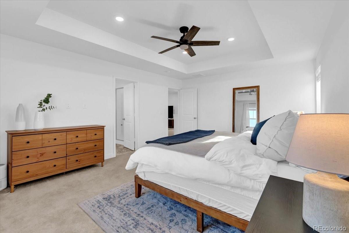 5453 Inland Avenue Firestone, CO 80504 - Photo 23 of 49 a bedroom with a bed and a dresser