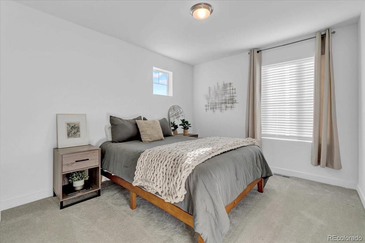 5453 Inland Avenue Firestone, CO 80504 - Photo 29 of 49 a bed sitting in a bedroom next to a window
