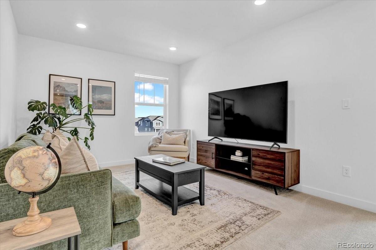 5453 Inland Avenue Firestone, CO 80504 - Photo 35 of 49 a living room with furniture and a flat screen tv