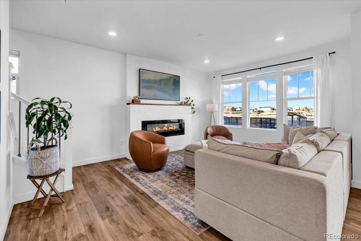 5453 Inland Avenue Firestone, CO 80504 - Photo 8 of 49 a living room with furniture and a potted plant