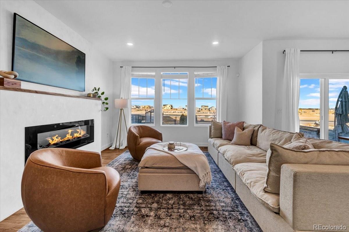 5453 Inland Avenue Firestone, CO 80504 - Photo 9 of 49 a living room with furniture and a fireplace