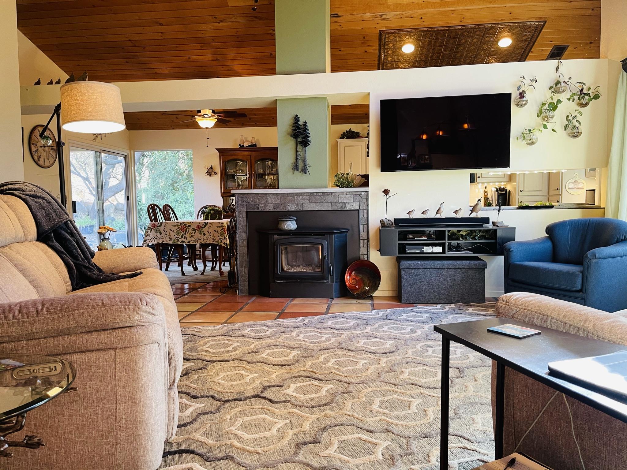 40964 Cherokee Oaks Drive Three Rivers, CA 93271 - Photo 14 of 41 a living room with furniture a flat screen tv and a fireplace