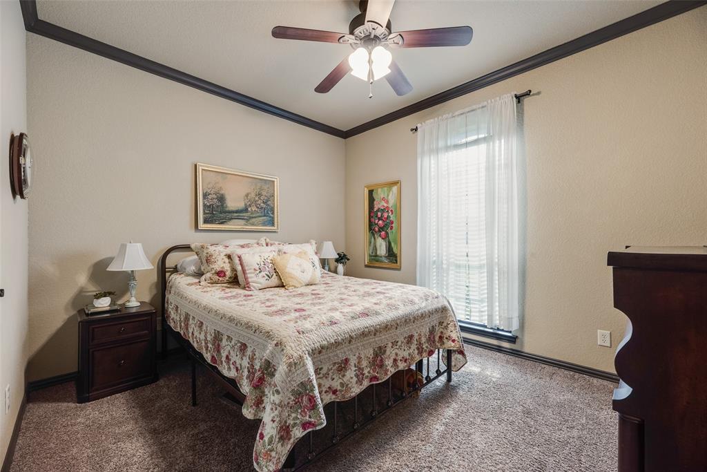 1132 Chartres Street Kaufman, TX 75142 - Photo 16 of 25 Carpeted room featuring a ceiling fan with integrated lighting, dark crown molding, and a window with blinds and sheer curtains