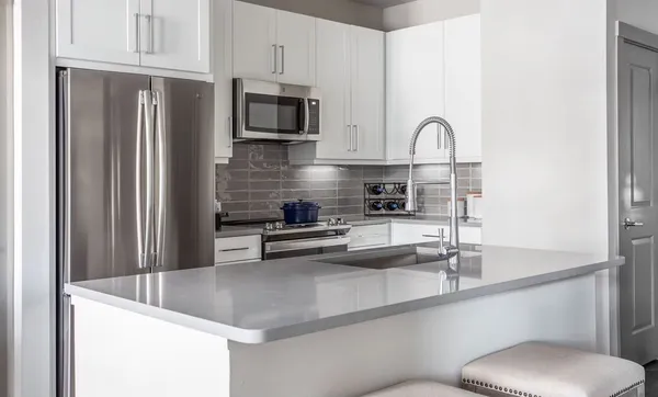 a kitchen with appliances a sink and cabinets