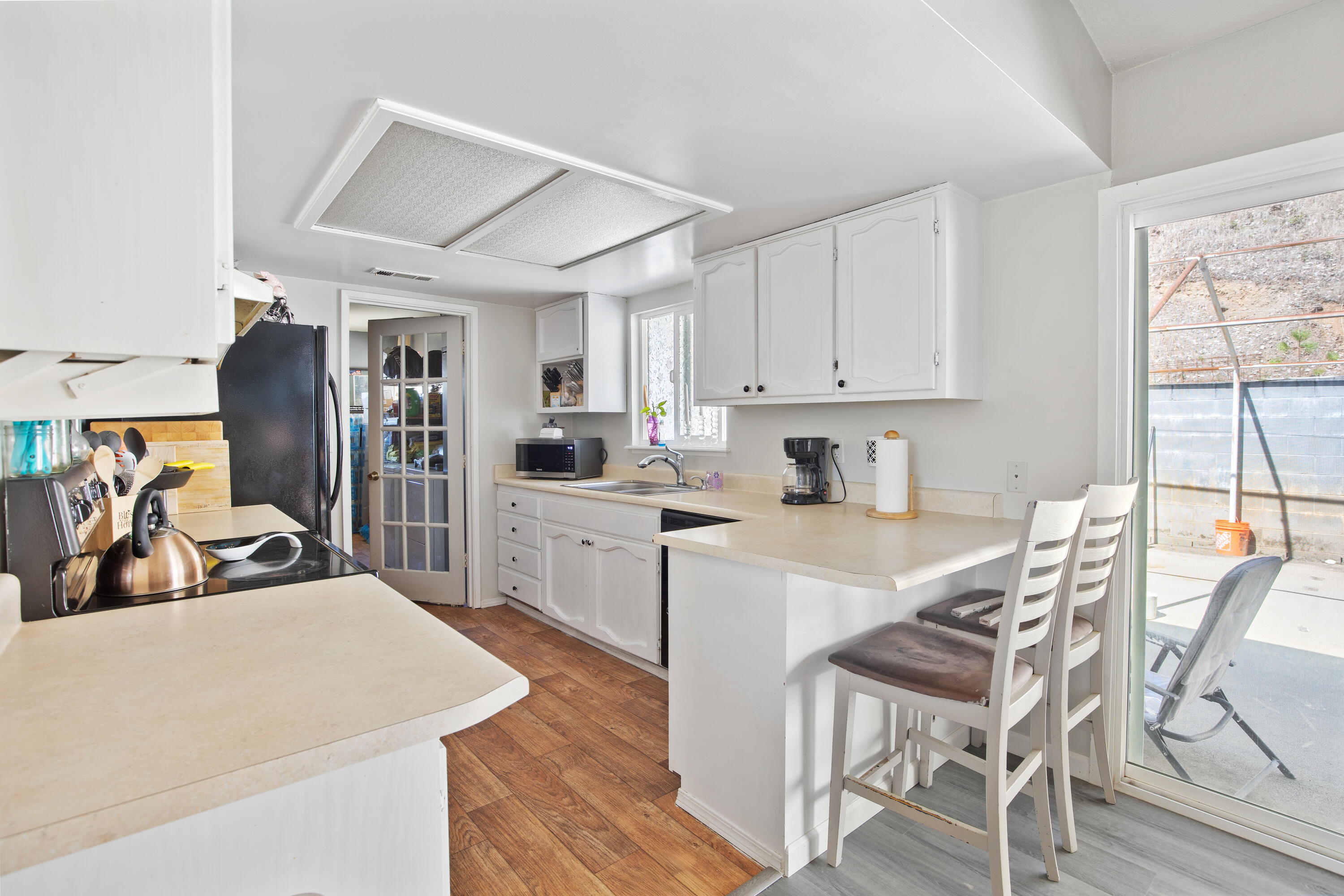12748 Water Gap Road Williams, OR 97544 - Photo 5 of 35 a kitchen with a table chairs refrigerator and cabinets
