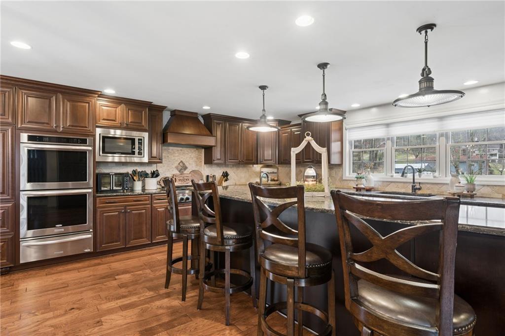 55 Spring Valley Drive Washington, PA 15301 - Photo 11 of 36 a kitchen with stainless steel appliances granite countertop a kitchen island hardwood floor and a sink