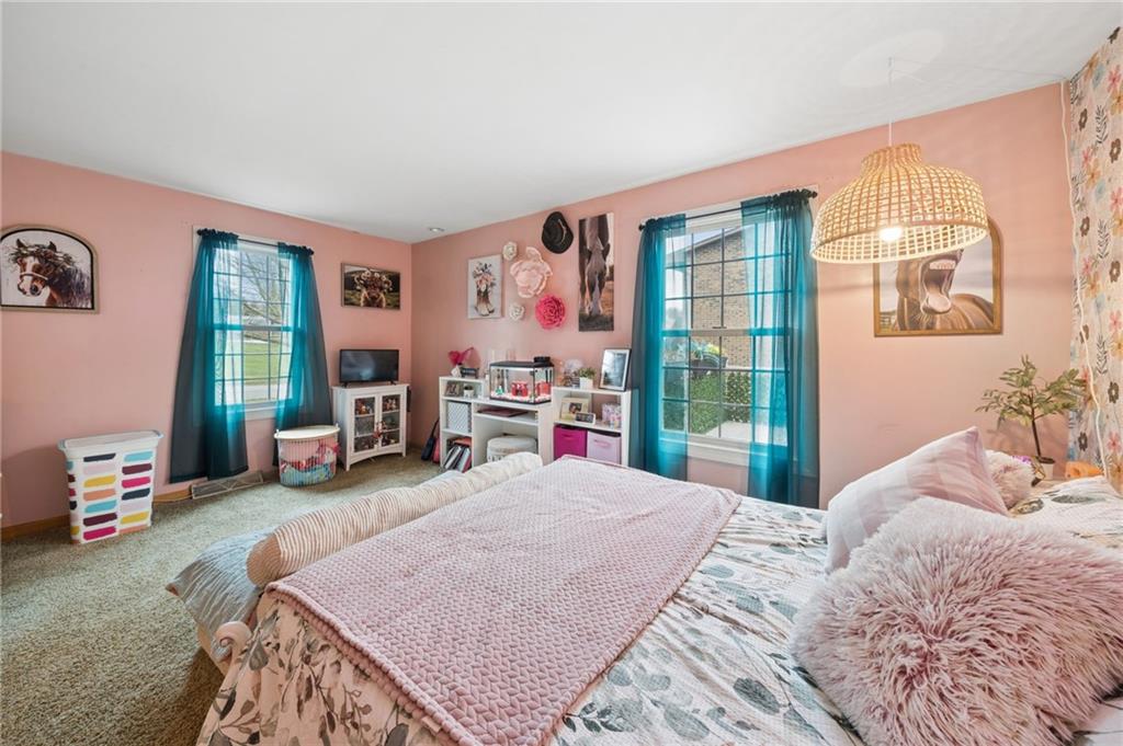 55 Spring Valley Drive Washington, PA 15301 - Photo 12 of 36 a bedroom with a bed a table and large windows