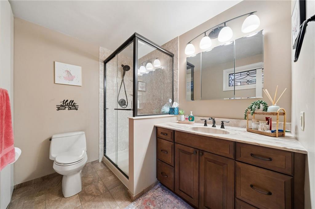55 Spring Valley Drive Washington, PA 15301 - Photo 14 of 36 a spacious bathroom with a toilet sink and mirror