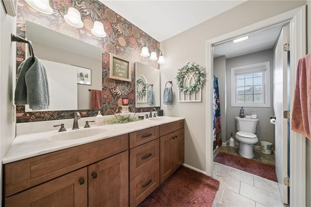 55 Spring Valley Drive Washington, PA 15301 - Photo 21 of 36 a spacious bathroom with a double vanity sink a mirror and a toilet