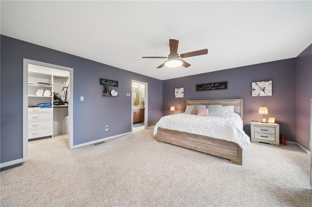 55 Spring Valley Drive Washington, PA 15301 - Photo 25 of 36 a spacious bedroom with a large bed and a chandelier