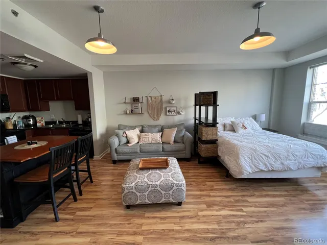 a view of a room with wooden floor and windows