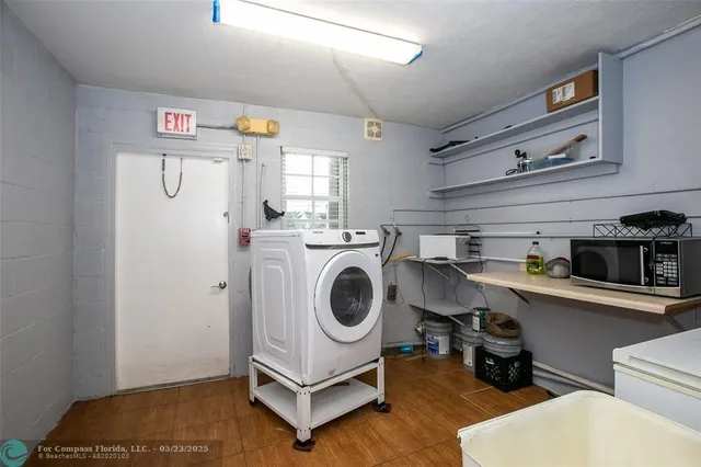 a utility room with sink dryer and washer