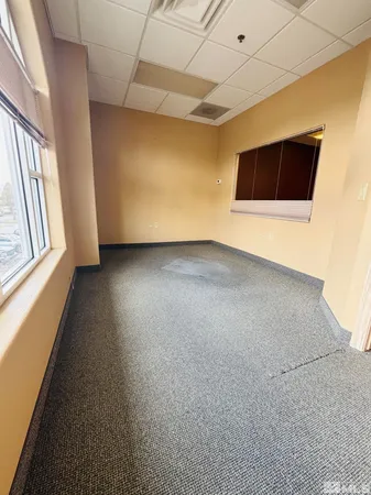 a room with pool table and windows