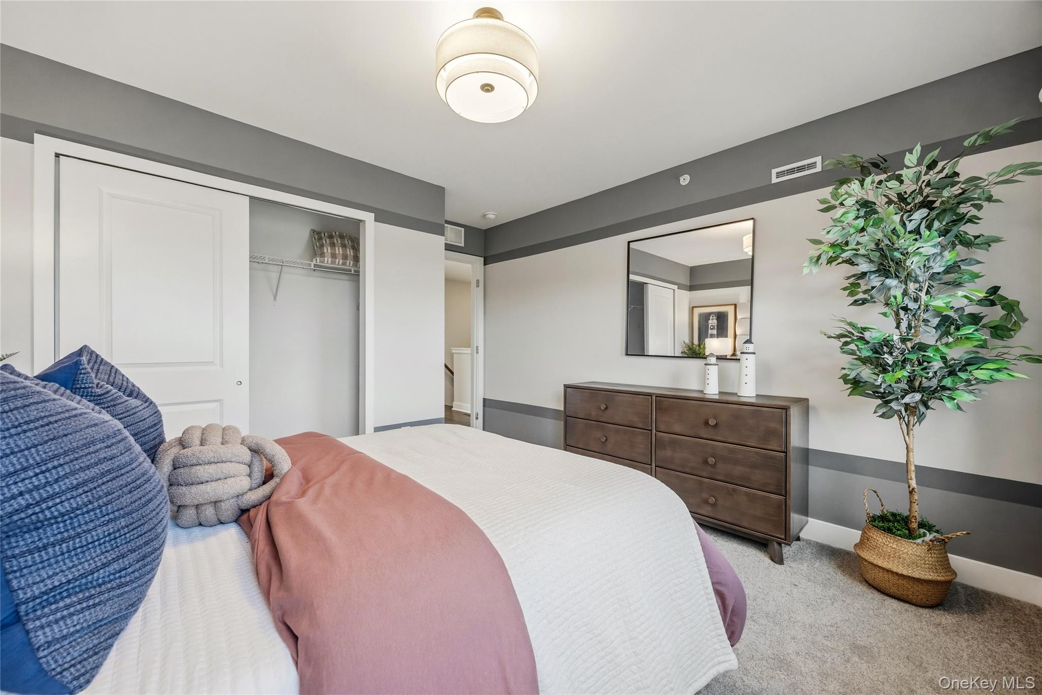 154 Pine Ridge Road Tuxedo Park, NY 10987 - Photo 14 of 25 a bedroom with a bed and a potted plant