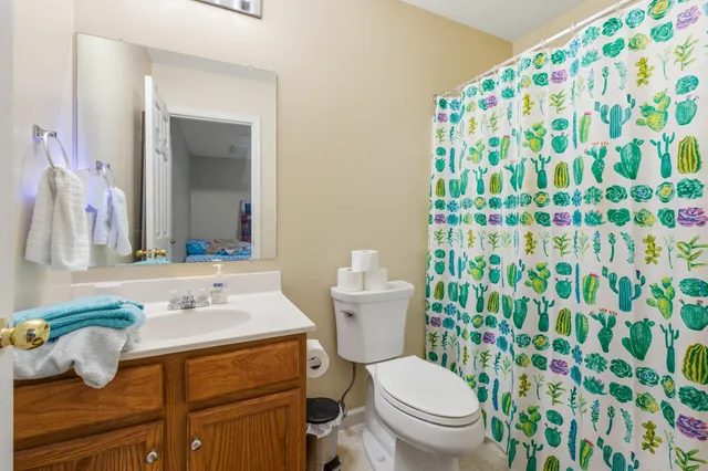 a bathroom with a sink toilet and mirror