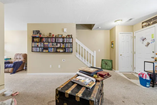 a room with furniture and book shelf