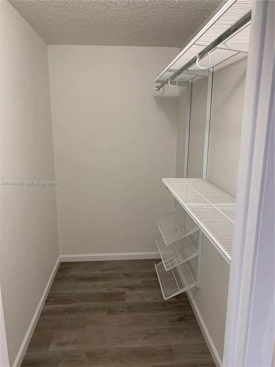 9273 Southwest 8th Street, Unit 411 Boca Raton, FL 33428 - Photo 14 of 21 a view of an empty walk in closet