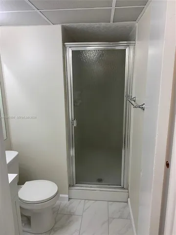 a bathroom with a glass shower door