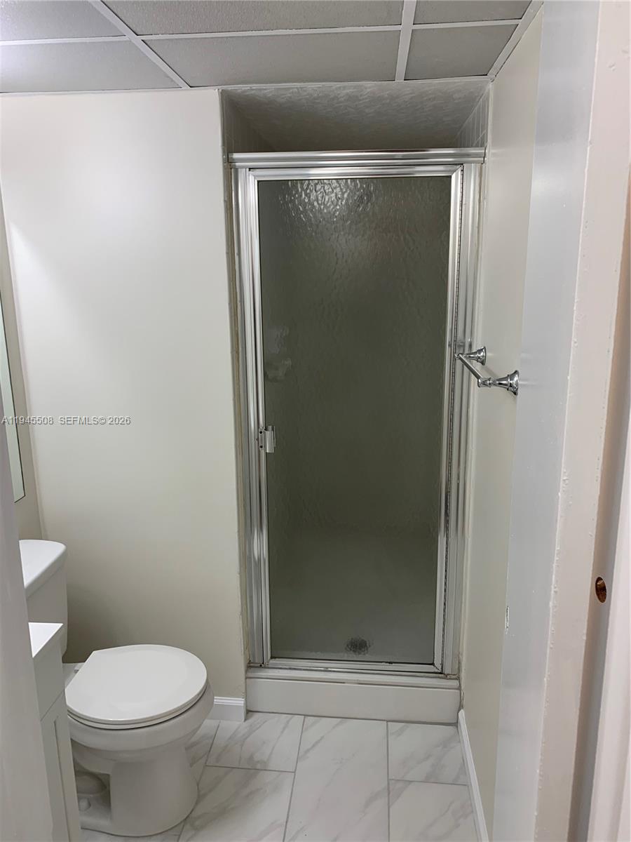 9273 Southwest 8th Street, Unit 411 Boca Raton, FL 33428 - Photo 17 of 21 a bathroom with a glass shower door