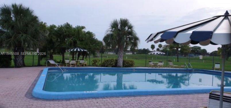 9273 Southwest 8th Street, Unit 411 Boca Raton, FL 33428 - Photo 20 of 21 a view of a fountain in front of a house