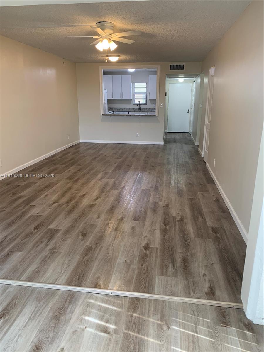 9273 Southwest 8th Street, Unit 411 Boca Raton, FL 33428 - Photo 2 of 21 a view of a room with wooden floor
