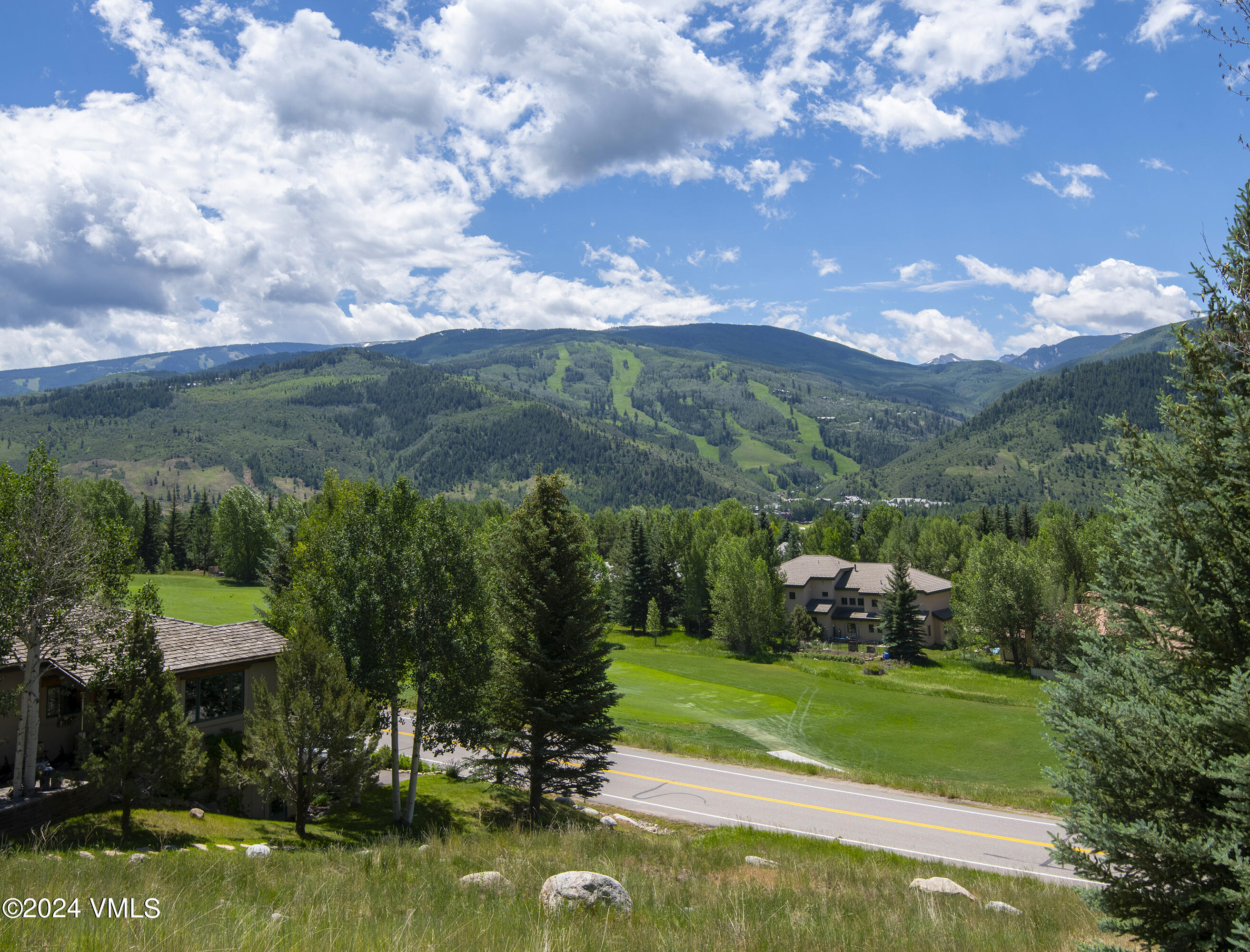 751 Singletree Road, Unit 3N Edwards, CO 81632 - Photo 9 of 35 a view of a garden with lawn chairs under an umbrella