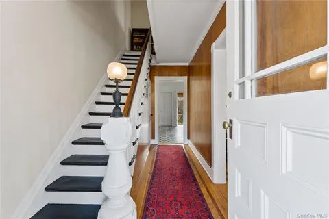 a view of entryway with furniture and stairs