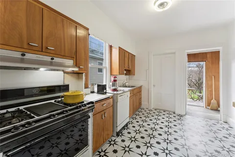 a kitchen with a sink a stove and cabinets