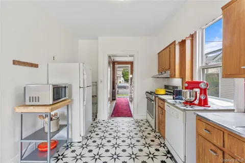 a kitchen that has a lot of cabinets and wooden floor