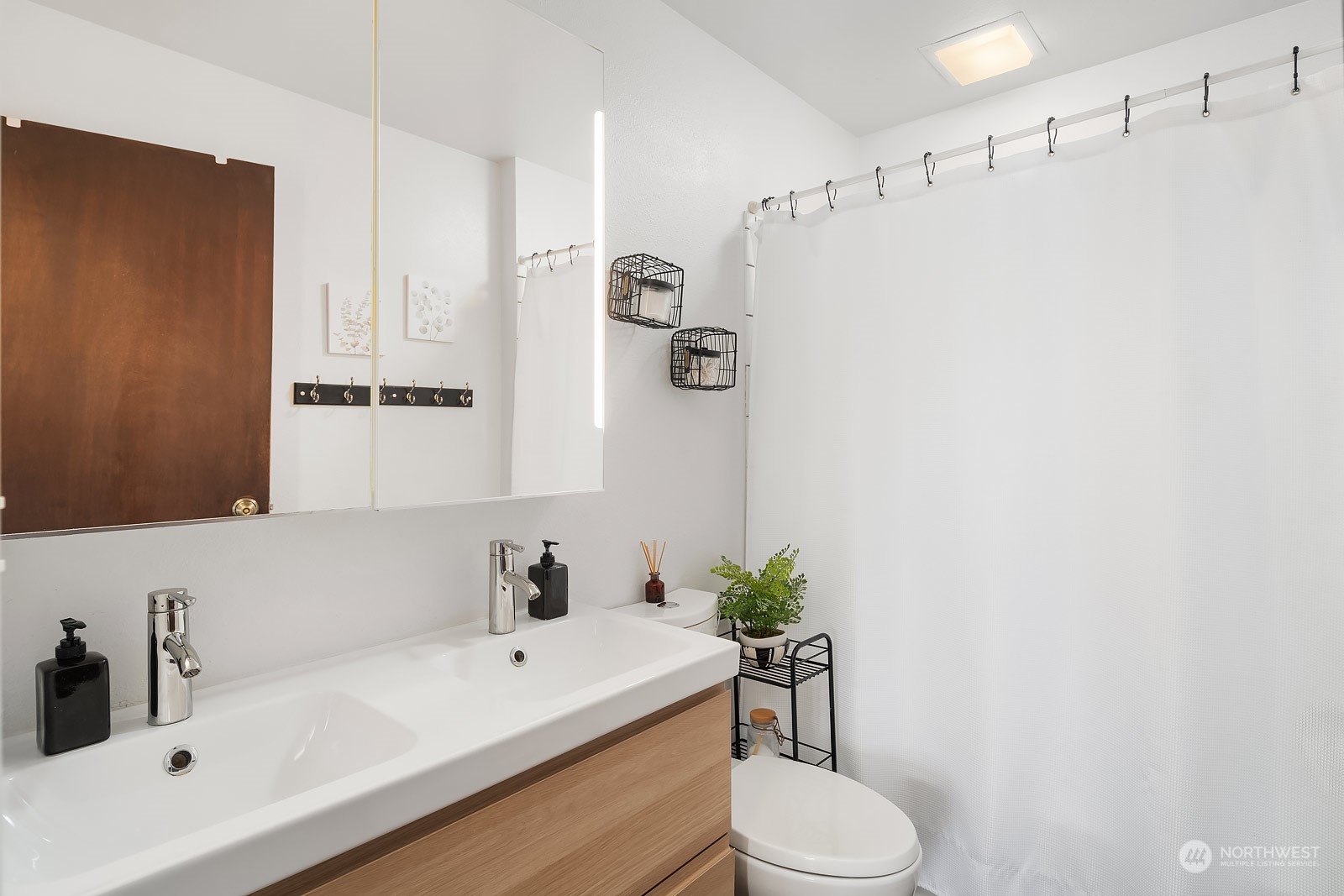 1202 North 29th Street Renton, WA 98056 - Photo 11 of 35 a bathroom with a sink a toilet and shower