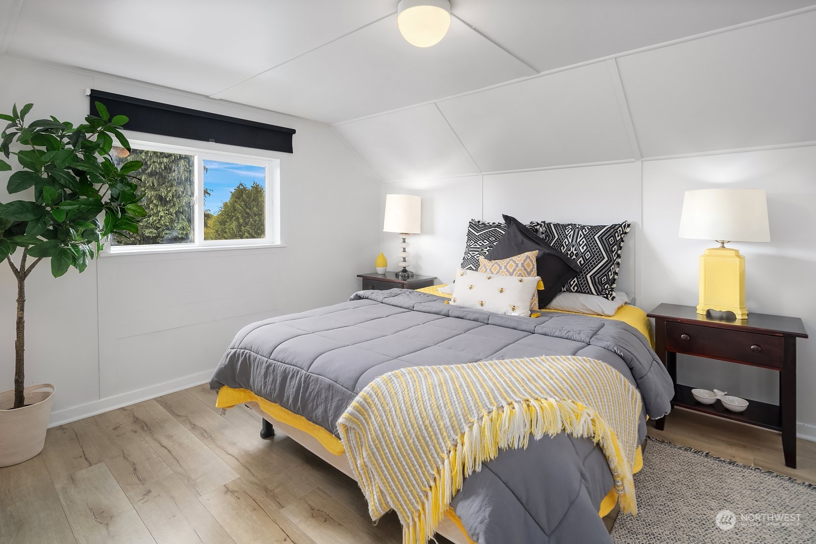 1202 North 29th Street Renton, WA 98056 - Photo 14 of 35 a bedroom with a bed lamp and a potted plant