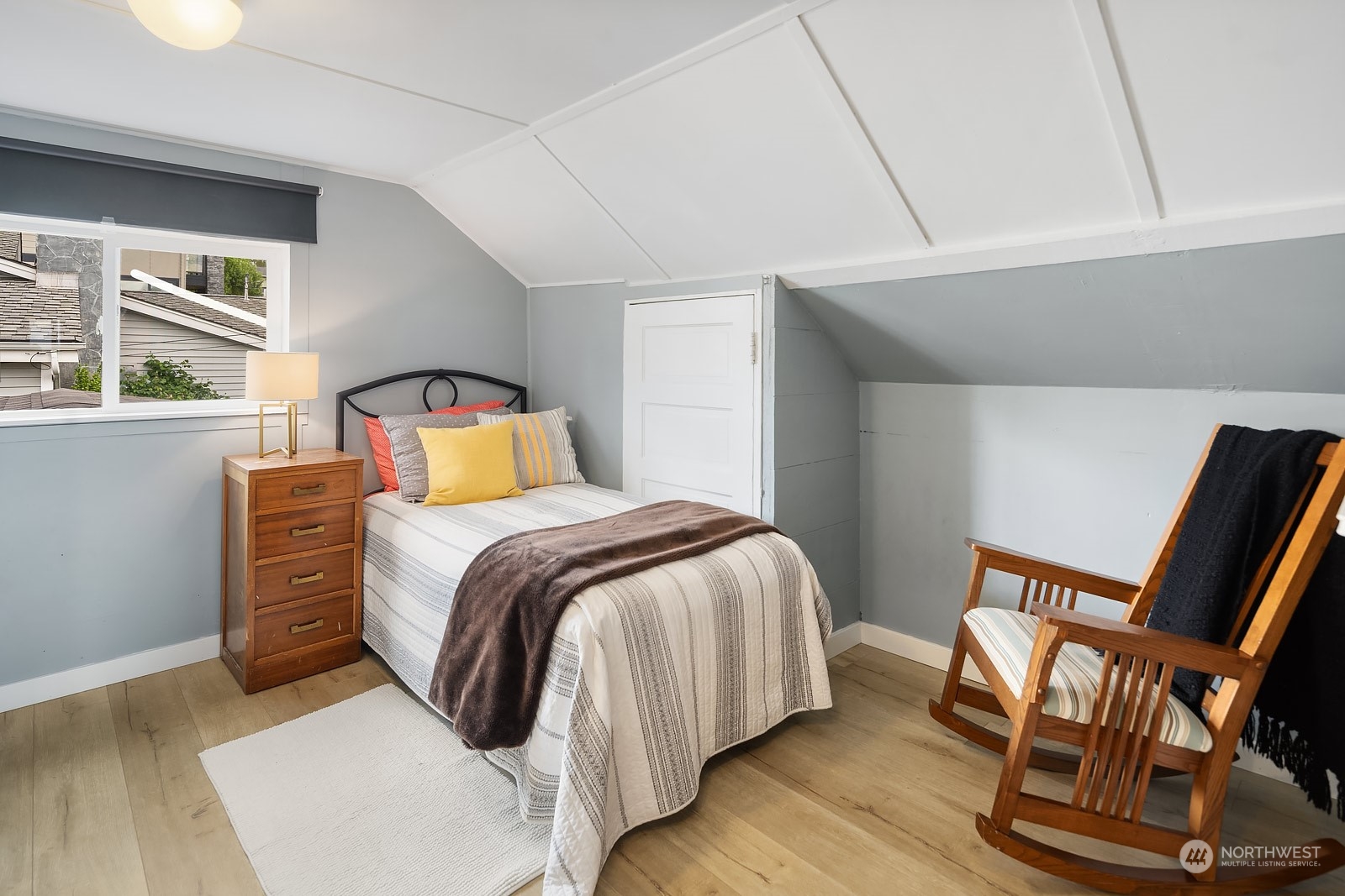 1202 North 29th Street Renton, WA 98056 - Photo 16 of 35 a bedroom with a bed and wooden floor