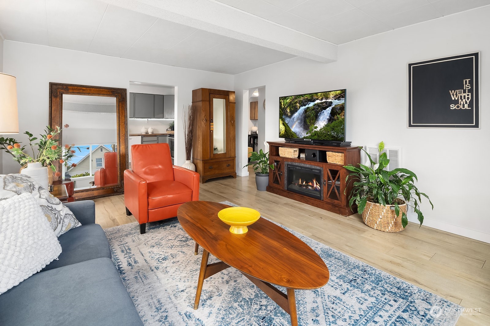 1202 North 29th Street Renton, WA 98056 - Photo 5 of 35 a living room with furniture a flat screen tv and a fireplace