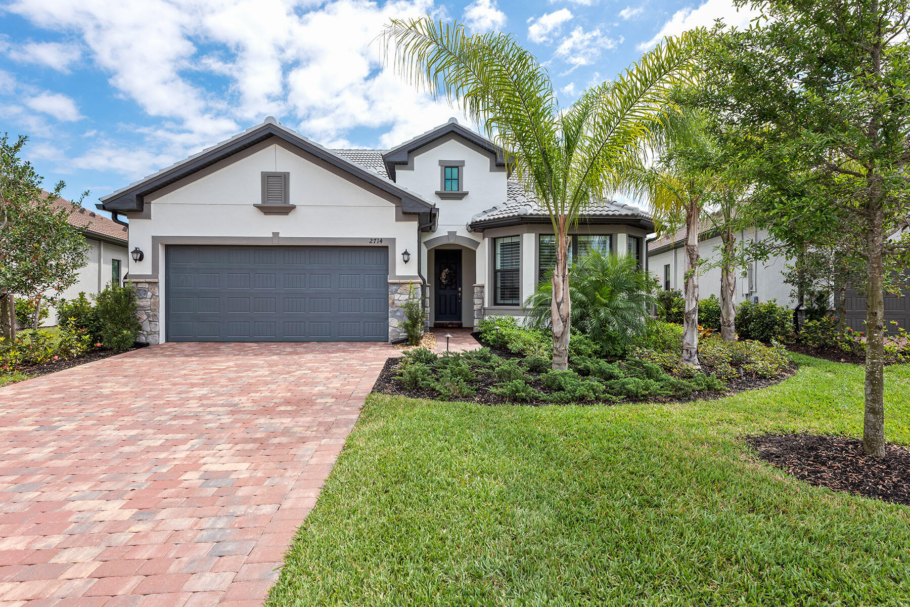 a front view of a house with a yard and garage