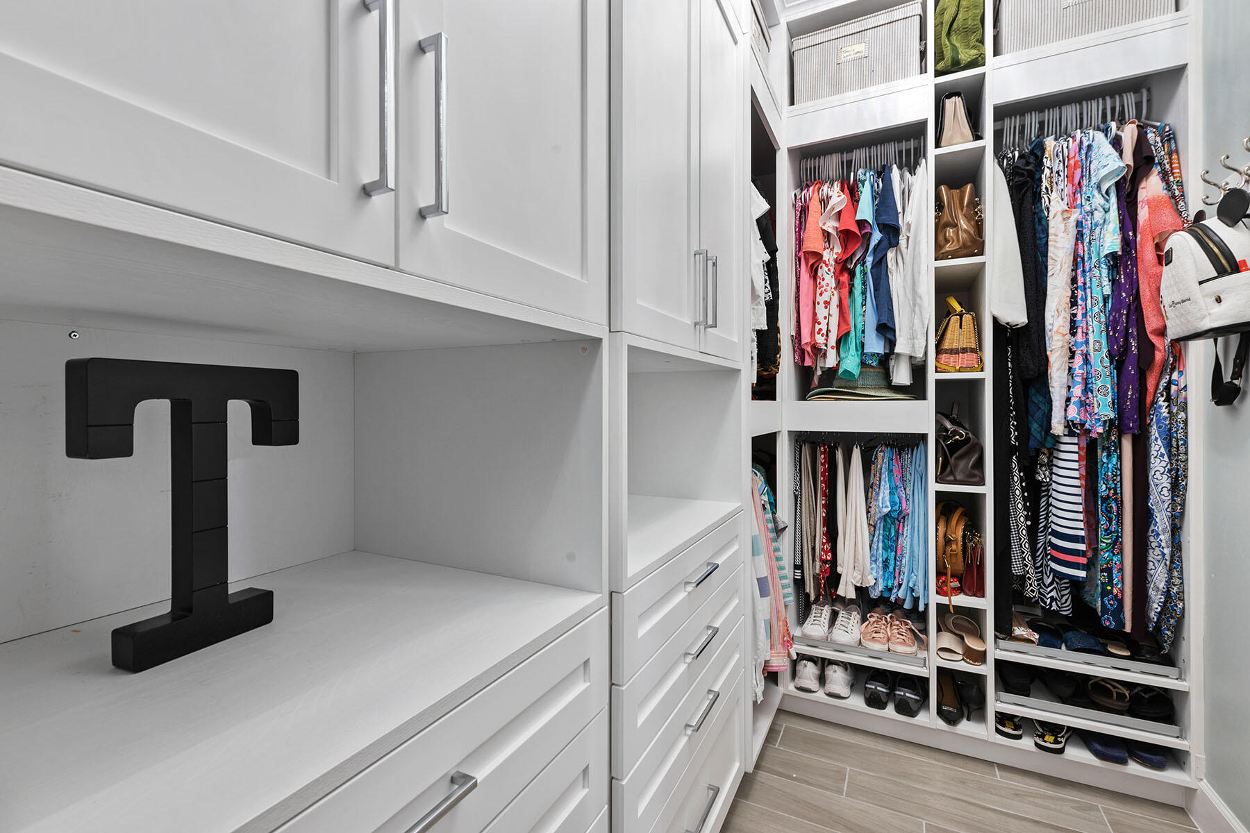 2714 Aviamar Circle Naples, FL 34114 - Photo 12 of 53 a view of walk in closet with clothes and shoes
