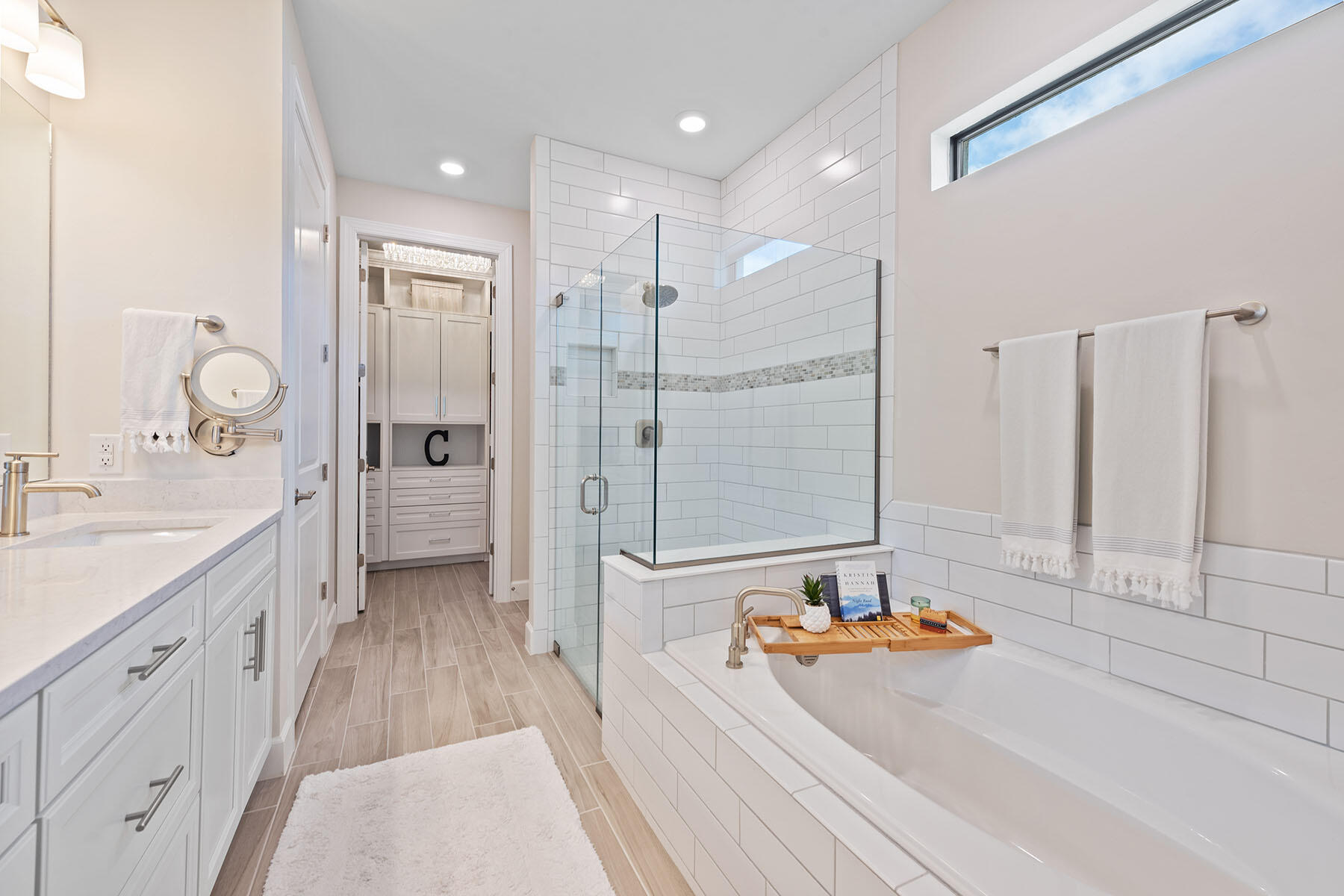 2714 Aviamar Circle Naples, FL 34114 - Photo 13 of 53 a bathroom with a tub a double vanity sink and mirror