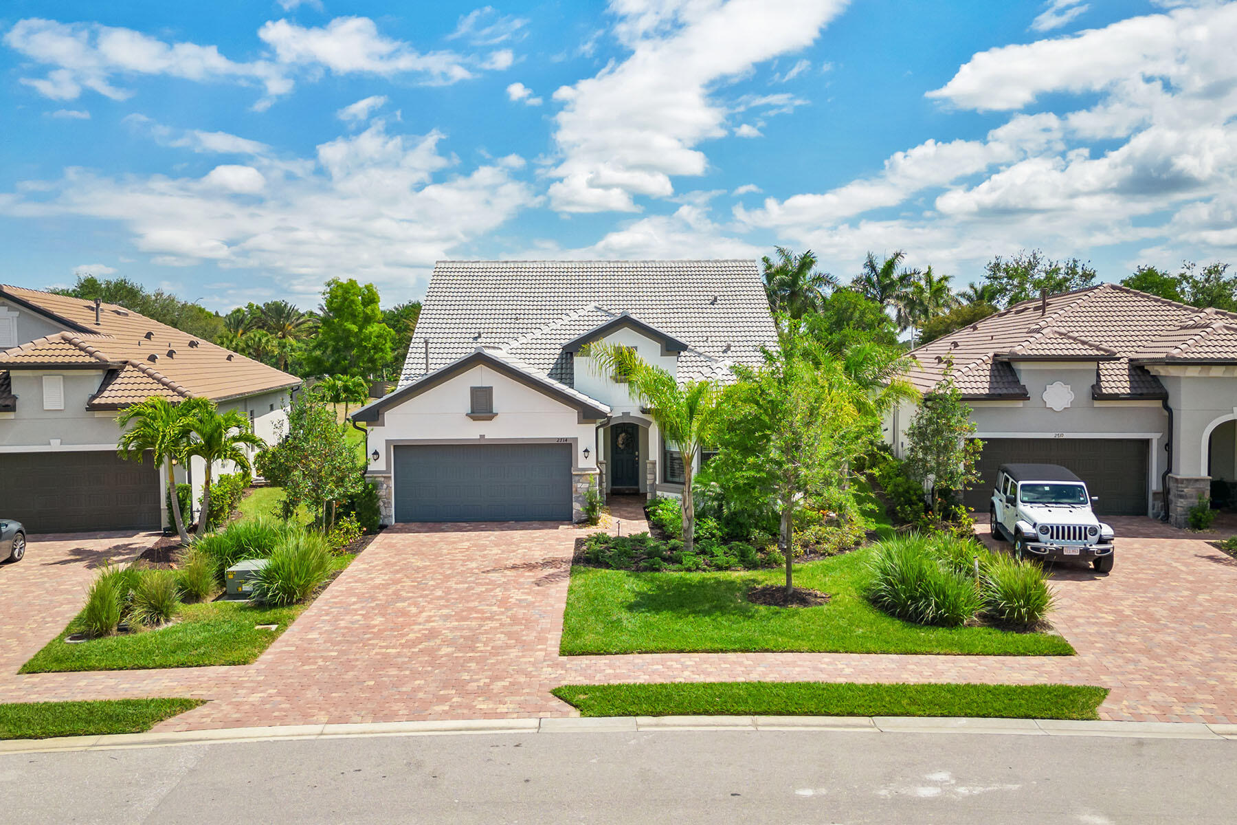 2714 Aviamar Circle Naples, FL 34114 - Photo 32 of 53 a front view of a house with a garden and trees