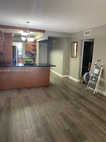 5500 Southwest 77th Court, Unit 201 Miami, FL 33155 - Photo 3 of 3 an empty room with wooden floor and windows