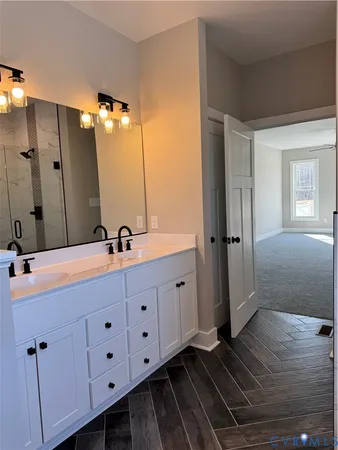 a bathroom with a double vanity sink and mirror