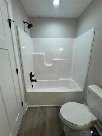 a bathroom with a toilet and a bathtub